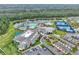 Aerial view of an active adult community's resort-style pool, tennis courts, and amenities center on a lake at 6105 Citrus Grove Ct, St Cloud, FL 34771