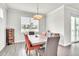 Cozy dining room with modern light fixture, views from the window, and stylish decor at 6105 Citrus Grove Ct, St Cloud, FL 34771