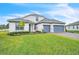 Charming two-story home with a well-maintained lawn and a brick paved driveway at 6105 Citrus Grove Ct, St Cloud, FL 34771