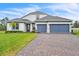 Charming two-story home with a brick driveway and a manicured front lawn at 6105 Citrus Grove Ct, St Cloud, FL 34771