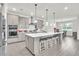 Stylish kitchen with a spacious island, stainless appliances, and pendant lights at 6105 Citrus Grove Ct, St Cloud, FL 34771