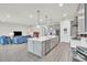 Bright, open kitchen featuring a large island with quartz countertop and stainless steel appliances at 6105 Citrus Grove Ct, St Cloud, FL 34771