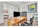 Bright office space features a wood desk, chair and views into the home at 6105 Citrus Grove Ct, St Cloud, FL 34771