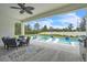 Outdoor pool and patio with a dining table, outdoor kitchen, lounge chairs, and a spacious seating area at 6105 Citrus Grove Ct, St Cloud, FL 34771
