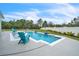 Backyard pool featuring lounge chairs and a seating area, surrounded by a well-maintained lawn at 6105 Citrus Grove Ct, St Cloud, FL 34771