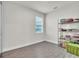 A storage room with vinyl wood floors, shelving, and one window at 6105 Citrus Grove Ct, St Cloud, FL 34771