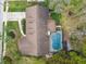 Overhead view of home featuring screened in pool, landscaping, and driveway at 743 Riverbend Blvd, Longwood, FL 32779