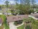 Aerial view of a charming home with a well-manicured front yard and an attached garage at 743 Riverbend Blvd, Longwood, FL 32779