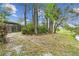 Private backyard with mature trees and a view of the pool and surrounding landscape at 743 Riverbend Blvd, Longwood, FL 32779