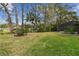 Expansive backyard features mature trees, lush grass, and a screened pool enclosure at 743 Riverbend Blvd, Longwood, FL 32779
