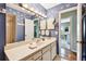 Unique bathroom featuring vanity with Hollywood lighting, blue walls, and starfish accents at 743 Riverbend Blvd, Longwood, FL 32779
