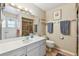 Well-lit bathroom featuring single vanity, decorative fixtures, and neutral color palette at 743 Riverbend Blvd, Longwood, FL 32779