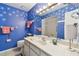 Charming blue bathroom with white starfish accents, vanity, and decorative towels and mirror at 743 Riverbend Blvd, Longwood, FL 32779