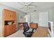 Neutral bedroom with ceiling fan features desk and storage, with bright natural light at 743 Riverbend Blvd, Longwood, FL 32779
