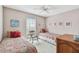 Cozy bedroom features twin beds with bright patterned linens and decorative pillows by a window at 743 Riverbend Blvd, Longwood, FL 32779