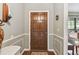 Inviting foyer with wood floors, a classic wood door, and decorative trim creating a welcoming entrance at 743 Riverbend Blvd, Longwood, FL 32779