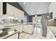 Well-lit kitchen featuring white cabinets, modern appliances, and an eat-in area perfect for casual dining at 743 Riverbend Blvd, Longwood, FL 32779