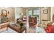 Bright and open living room with large window, hardwood floors, and cozy floral print seating at 743 Riverbend Blvd, Longwood, FL 32779