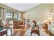 Bright living room with hardwood floors, a large window, and comfortable seating for relaxation at 743 Riverbend Blvd, Longwood, FL 32779