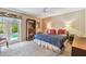Cozy bedroom with ceiling fan, private patio entrance, and ample natural light at 743 Riverbend Blvd, Longwood, FL 32779