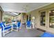 Inviting screened patio features comfortable seating, ceiling fan and double door access to the home at 743 Riverbend Blvd, Longwood, FL 32779