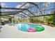 Enclosed pool area with a beautiful pool, lush plants and outdoor seating at 743 Riverbend Blvd, Longwood, FL 32779