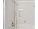 Clean white tiled shower and tub combo with updated shower head and convenient grab bar at 743 Riverbend Blvd, Longwood, FL 32779