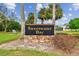 Sweetwater Bay community sign set amidst lush landscaping and mature trees at 743 Riverbend Blvd, Longwood, FL 32779