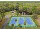 Aerial view of the tennis courts next to a lake and canoes, surrounded by trees at 743 Riverbend Blvd, Longwood, FL 32779