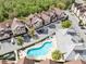 Aerial view of condos, pool, parking area, and surrounding landscaping at 7558 Sunflower Cir, Kissimmee, FL 34747