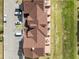 Aerial view of a complex featuring brown roofs, parking, patios, and a lawn at 7558 Sunflower Cir, Kissimmee, FL 34747