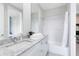 Inviting bathroom featuring a granite countertop, ample vanity space, and a shower-tub combo at 7558 Sunflower Cir, Kissimmee, FL 34747