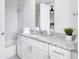 Well-lit bathroom featuring a marble-look shower and a vanity with granite countertop at 7558 Sunflower Cir, Kissimmee, FL 34747