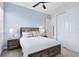 Charming bedroom with rustic wood bed frame and soft, neutral decor at 7558 Sunflower Cir, Kissimmee, FL 34747
