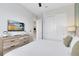 Comfortable bedroom featuring a television, closet, and serene decor at 7558 Sunflower Cir, Kissimmee, FL 34747