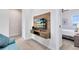 Cozy bedroom with wall-mounted TV and a glimpse into another room at 7558 Sunflower Cir, Kissimmee, FL 34747