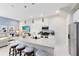 Modern kitchen with a granite island, stainless steel appliances, and open access to the living room at 7558 Sunflower Cir, Kissimmee, FL 34747