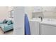 Functional laundry room with modern appliances, storage shelves, and a convenient ironing board at 7558 Sunflower Cir, Kissimmee, FL 34747