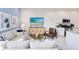 Bright living room with modern decor, stylish furniture, and open layout to the kitchen at 7558 Sunflower Cir, Kissimmee, FL 34747
