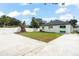 An ample backyard features fresh green grass, patio area, modern white fence and home exterior at 7633 Marietta St, Orlando, FL 32807