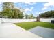 Spacious backyard with lush grass, patio, and privacy fence perfect for entertaining or relaxation at 7633 Marietta St, Orlando, FL 32807