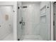 Elegant bathroom has a glass enclosed shower with a luxurious rainfall showerhead at 7633 Marietta St, Orlando, FL 32807
