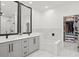 Elegant bathroom with dual vanity, soaking tub, marble accents, and walk-in closet at 7633 Marietta St, Orlando, FL 32807