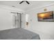 The primary bedroom has a sunset view, large TV, and en suite bath with glass shower at 7633 Marietta St, Orlando, FL 32807