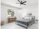 Bright bedroom with a bed, bookshelf, and a window overlooking the greenery outside at 7633 Marietta St, Orlando, FL 32807
