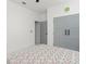 The bedroom features modern grey closet doors, closet, and a ceiling fan at 7633 Marietta St, Orlando, FL 32807