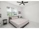Bright bedroom with a bed, side tables, large windows and hardwood floors at 7633 Marietta St, Orlando, FL 32807