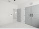 Neutral bedroom featuring double closets and a view into the entry with marble floors at 7633 Marietta St, Orlando, FL 32807