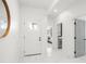 Bright foyer featuring white walls, decorative mirror, and sleek tile flooring at 7633 Marietta St, Orlando, FL 32807