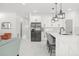 Bright open kitchen features white cabinets, marble countertops, and stainless steel appliances at 7633 Marietta St, Orlando, FL 32807